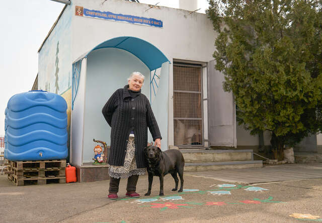 Alla stands with her dog.